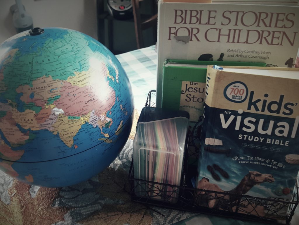 Components of Morning Time for our Charlotte Mason homeschool including globe, Bible, storybook bibles, and verse cards