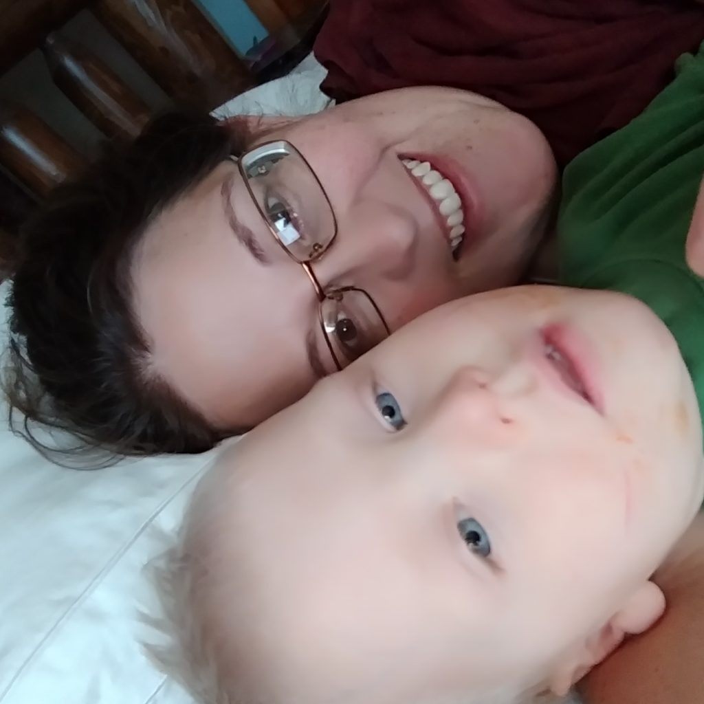 Mother and son laying on pillow before naptime